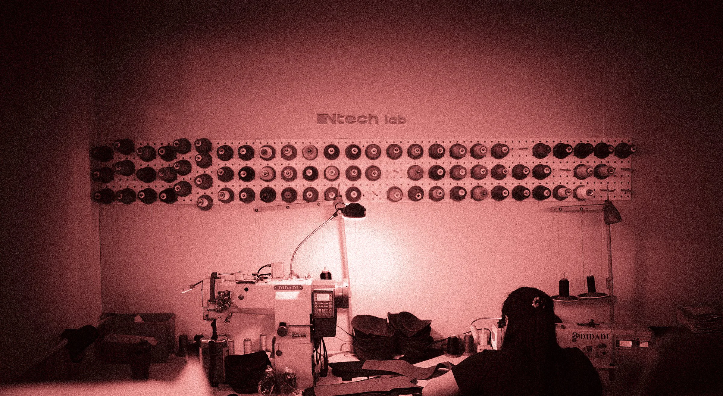 Ntech lab — workshop wall of thread spools and sewing station
