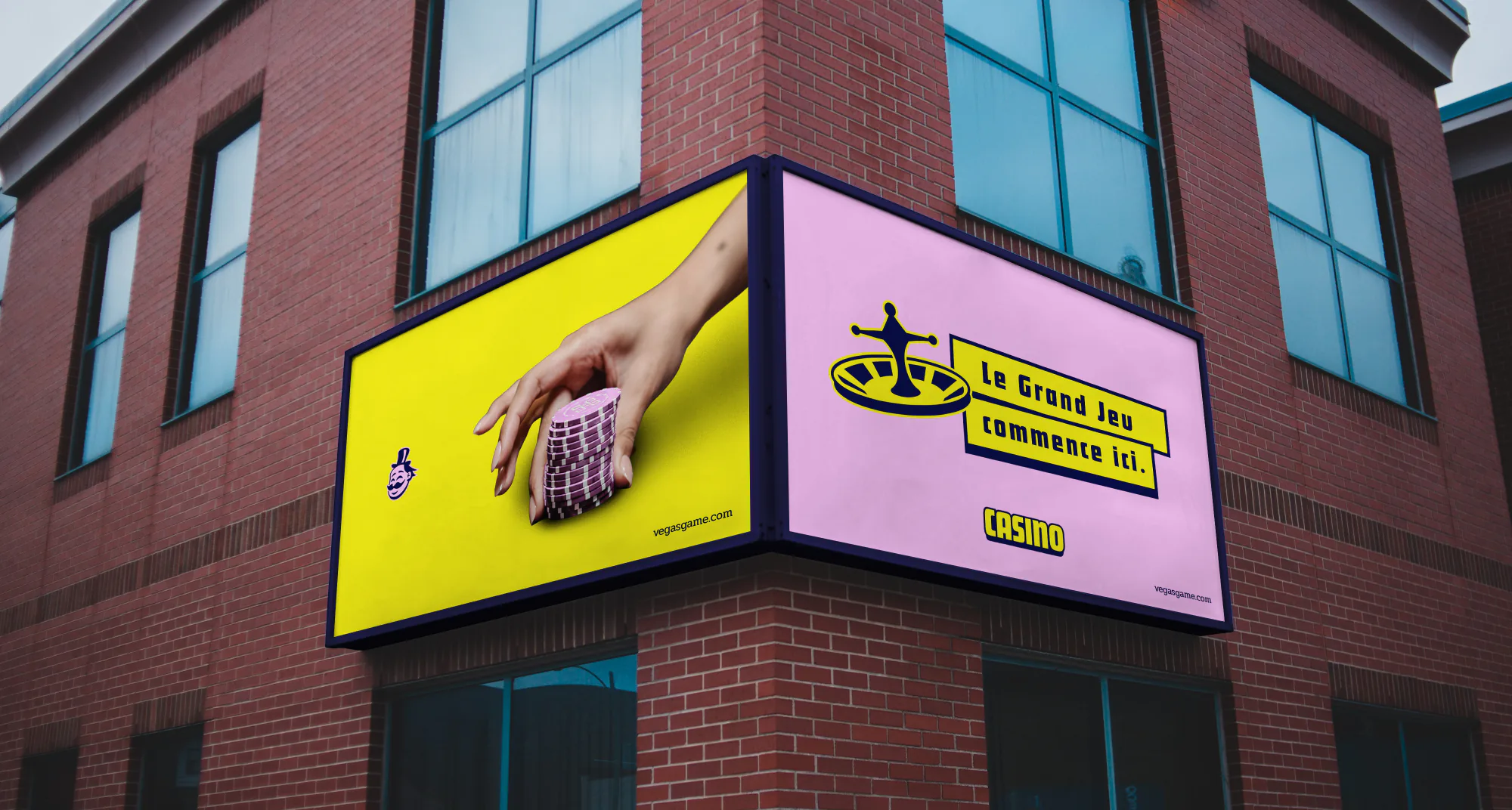 Vegas Game billboards on a corner building facade, yellow and pink